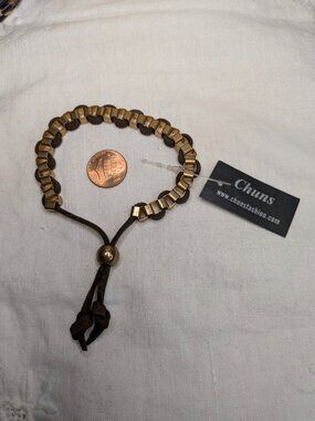 Chun’s Gold Tone Ladder Bracelet – Brown Leather Cord